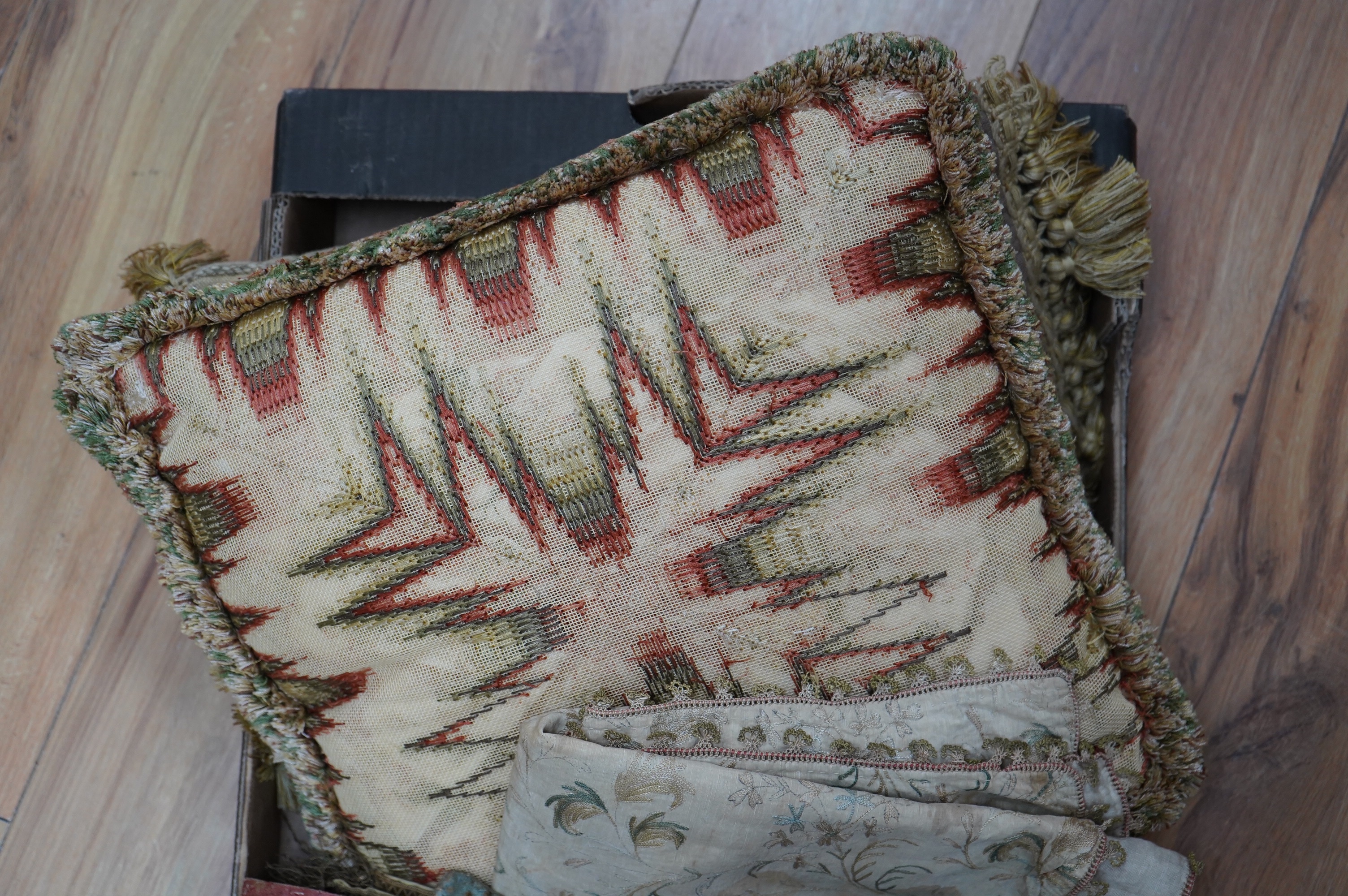 A collection of 18th and 19th century textiles, to include religious Maniples, two cushions, an embroidered chain stitch table cover with intricate edging, a Chinese embroidered panel and floral painted satin. Condition